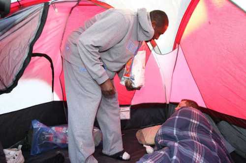 Patrick Patterson wakes a thankless tent hobo with a piping hot McMuffin.